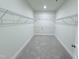 Spacious walk-in closet with ample shelving and neutral carpet for easy organization and storage at 85 Claude Creek Way, Smithfield, NC 27577