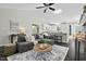 Comfortable living room featuring a gray sofa, round coffee table, and a ceiling fan at 5336 Covington Cross Dr, Knightdale, NC 27545