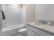 Well-lit bathroom featuring tiled shower and tub, vanity and neutral countertops at 1029 Whitehall Cir, Durham, NC 27713