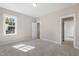 Carpeted bedroom boasts natural light through a single window and views into the hall at 1029 Whitehall Cir, Durham, NC 27713