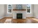Stylish fireplace with a wooden mantle and tile surround at 1029 Whitehall Cir, Durham, NC 27713