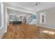 Open-concept living room flows into the kitchen featuring hardwood floors and staircase at 1029 Whitehall Cir, Durham, NC 27713