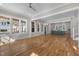 Bright and airy living room flows into the kitchen featuring hardwood floors and large windows at 1029 Whitehall Cir, Durham, NC 27713