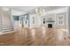 Open-concept living space with hardwood floors, natural light, and a fireplace at 1029 Whitehall Cir, Durham, NC 27713