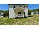 View of the back of the house with a small porch and grass yard at 199 Grand Griffon Way, Lillington, NC 27546
