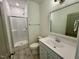 Modern bathroom featuring a tiled shower, gray tile floor, white sink, and white vanity at 199 Grand Griffon Way, Lillington, NC 27546