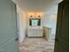 Bright bathroom showcasing a double sink vanity, tub, neutral walls and floors, and modern fixtures at 199 Grand Griffon Way, Lillington, NC 27546