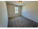 Bright bedroom with carpet flooring and a window at 199 Grand Griffon Way, Lillington, NC 27546