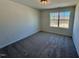 Bedroom with neutral carpet and a bright window showcasing the backyard at 199 Grand Griffon Way, Lillington, NC 27546