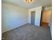 Neutral bedroom with a gray door and plush gray carpet at 199 Grand Griffon Way, Lillington, NC 27546