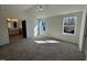 Inviting bedroom features plush carpet, two windows, and an ensuite bathroom entrance, creating a private space at 199 Grand Griffon Way, Lillington, NC 27546