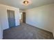 Bedroom featuring carpet floors, grey door, and neutral paint at 199 Grand Griffon Way, Lillington, NC 27546