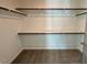Walk-in closet with shelves and rod is carpeted for storing clothing and other personal belongings at 199 Grand Griffon Way, Lillington, NC 27546