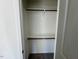 A compact walk-in closet featuring built-in shelving and a hanging rod for optimal clothing storage at 199 Grand Griffon Way, Lillington, NC 27546