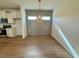 Dining area adjacent to the kitchen, featuring a modern light fixture at 199 Grand Griffon Way, Lillington, NC 27546