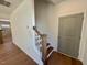 Welcoming entryway featuring hardwood floors, stairs to the upper level, and a convenient coat closet at 199 Grand Griffon Way, Lillington, NC 27546