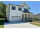 Two-story white home with stone accents, two car garage, and modern black shutters at 199 Grand Griffon Way, Lillington, NC 27546