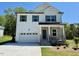 Beautiful two-story home featuring a stone facade, white siding, and a two-car garage at 199 Grand Griffon Way, Lillington, NC 27546