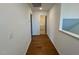 Hallway leading to the bathroom, featuring hardwood floors at 199 Grand Griffon Way, Lillington, NC 27546