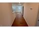 Hallway leading to bedroom with hardwood flooring and a view of the bedroom at 199 Grand Griffon Way, Lillington, NC 27546
