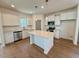 Modern kitchen with white cabinetry, stainless steel appliances, and a center island at 199 Grand Griffon Way, Lillington, NC 27546