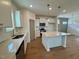 Well-lit kitchen with modern appliances, island, and a view to dining area at 199 Grand Griffon Way, Lillington, NC 27546