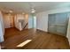 Open living area with hardwood floors, access to stairs, and multiple doorways leading to other rooms at 199 Grand Griffon Way, Lillington, NC 27546