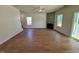 Spacious living room with hardwood floors, fireplace, and natural light from multiple windows at 199 Grand Griffon Way, Lillington, NC 27546