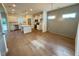 Open-concept living space with hardwood floors, kitchen with island, and stylish light fixture at 199 Grand Griffon Way, Lillington, NC 27546