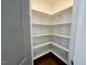 Spacious pantry with ample shelving for organized storage and hardwood floors at 199 Grand Griffon Way, Lillington, NC 27546