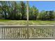 View from a screened porch looking out over grass and trees at 199 Grand Griffon Way, Lillington, NC 27546