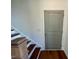 Wooden staircase with a neutral-toned wall and door at 199 Grand Griffon Way, Lillington, NC 27546