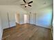 Bright bedroom with hardwood floors and multiple doors leading to other rooms at 217 Grand Griffon Way, Lillington, NC 27546