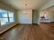 Elegant dining room featuring hardwood floors, wainscoting, a modern chandelier, and ample natural light at 217 Grand Griffon Way, Lillington, NC 27546