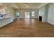 Bright and airy living room showcasing hardwood floors, a modern fireplace, and an open layout to the kitchen at 217 Grand Griffon Way, Lillington, NC 27546