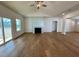 Bright living room featuring hardwood floors, a modern fireplace, and water view at 217 Grand Griffon Way, Lillington, NC 27546