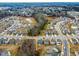 An aerial view of a residential community reveals orderly rows of homes, surrounded by lush greenery and scenic views at 313 Mason Oaks Dr, Wake Forest, NC 27587