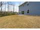 The sliding glass door leading to a backyard patio, set in a large uncultivated yard area, leads out to the forest at 313 Mason Oaks Dr, Wake Forest, NC 27587