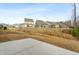 A cement patio offers backyard views of lush foliage of the forest line, with the neighborhood beyond at 313 Mason Oaks Dr, Wake Forest, NC 27587
