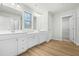 Bathroom featuring double sink vanity, wood look floors, and a window for natural light at 313 Mason Oaks Dr, Wake Forest, NC 27587
