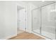 Bathroom featuring glass enclosed shower, neutral paint, and an open doorway to a closet at 313 Mason Oaks Dr, Wake Forest, NC 27587
