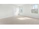 Bright bedroom features neutral carpet, white trim, and plenty of natural light from the double windows at 313 Mason Oaks Dr, Wake Forest, NC 27587
