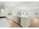 Bright kitchen features white cabinets, stainless steel appliances, and a large island at 313 Mason Oaks Dr, Wake Forest, NC 27587