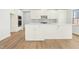Stylish kitchen with white cabinetry, stainless steel appliances, and large center island at 313 Mason Oaks Dr, Wake Forest, NC 27587