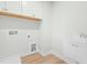Laundry room featuring white cabinets and sink, wood-look flooring, and light paint at 313 Mason Oaks Dr, Wake Forest, NC 27587