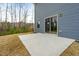 A sliding glass door leading to a concrete backyard patio, perfect for outdoor relaxation at 313 Mason Oaks Dr, Wake Forest, NC 27587