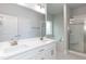 Bright bathroom featuring double sinks, white cabinets, a soaking tub, and glass enclosed shower at 499 Glenkirk Pl # 101, Garner, NC 27529
