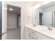 Bathroom featuring double sinks, white cabinets and a modern mirror at 499 Glenkirk Pl # 101, Garner, NC 27529