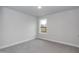 Neutral bedroom with grey carpet, and a bright window with outside view at 499 Glenkirk Pl # 101, Garner, NC 27529