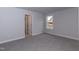 Cozy bedroom featuring light-colored walls, plush carpet, and one window at 499 Glenkirk Pl # 101, Garner, NC 27529